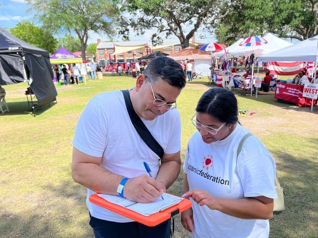 Latino man signing up for Voter Registration with Hispanic Federation