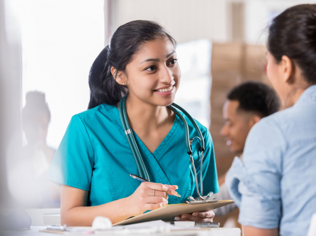 Attentive young doctor talks with female patient