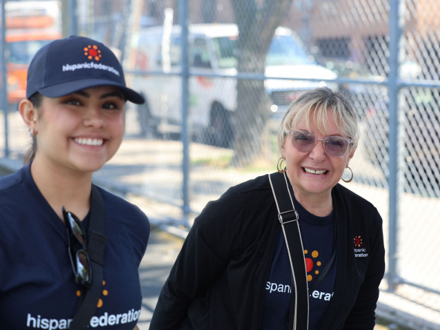 two smiling women who are working the GUGM event